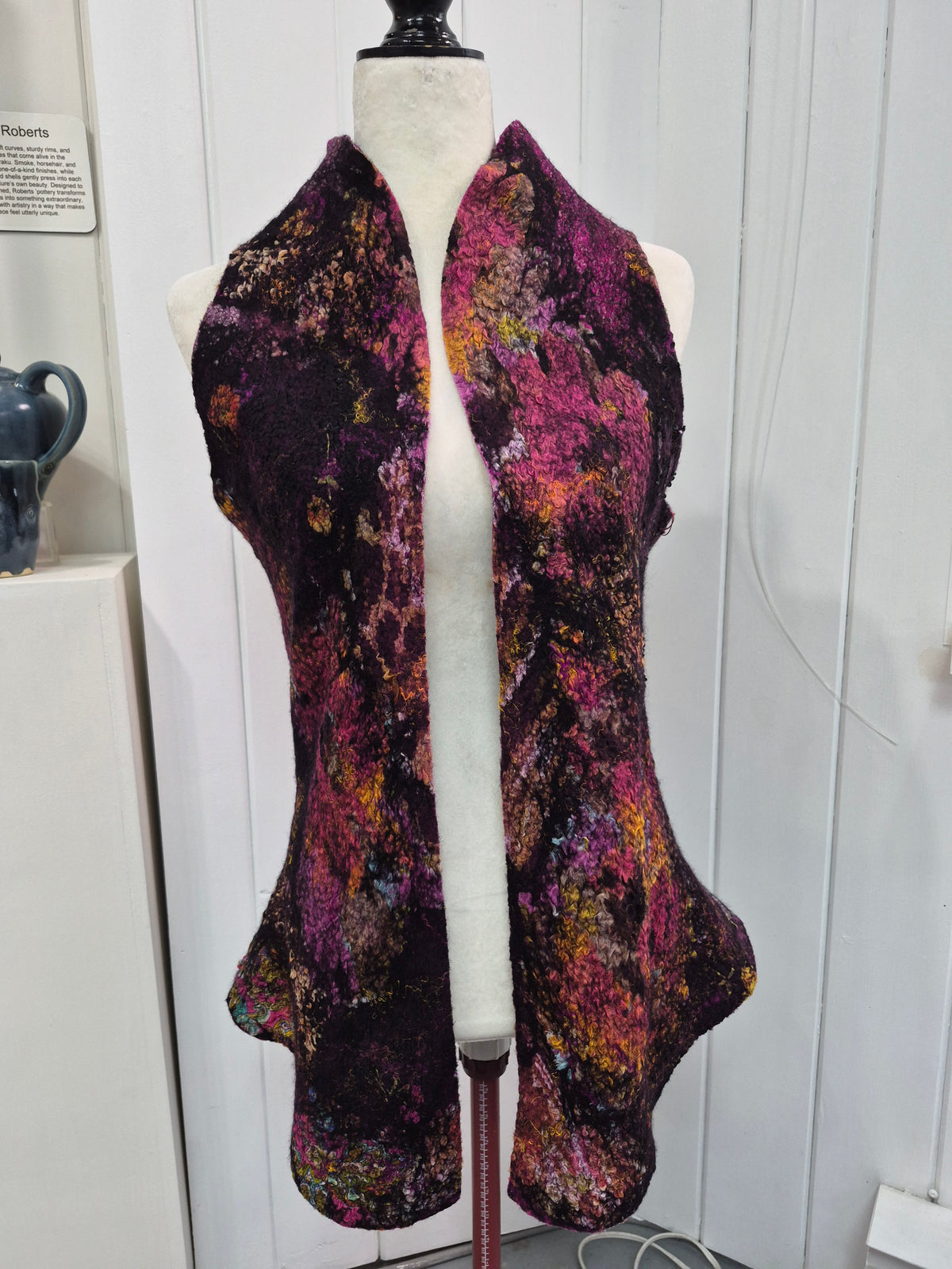 Black open-front vest by Denise Uebele with fuchsia, purple, and golden textured accents