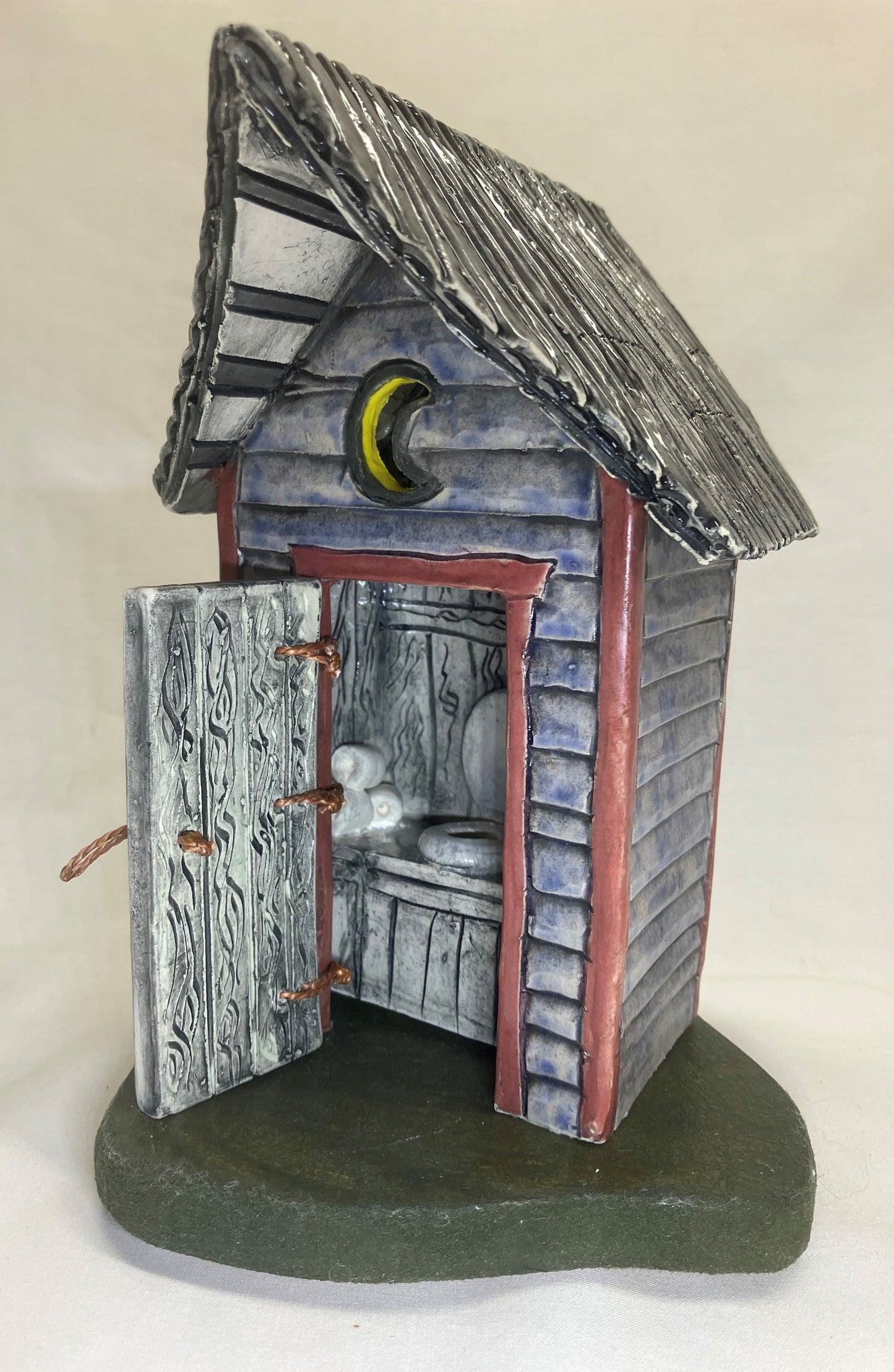 Grey and red outhouse