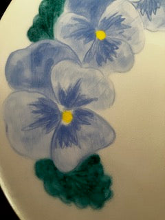 Baby blue pansies early blooms in the garden