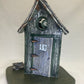 Grey and green outhouse