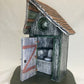 Grey and green outhouse