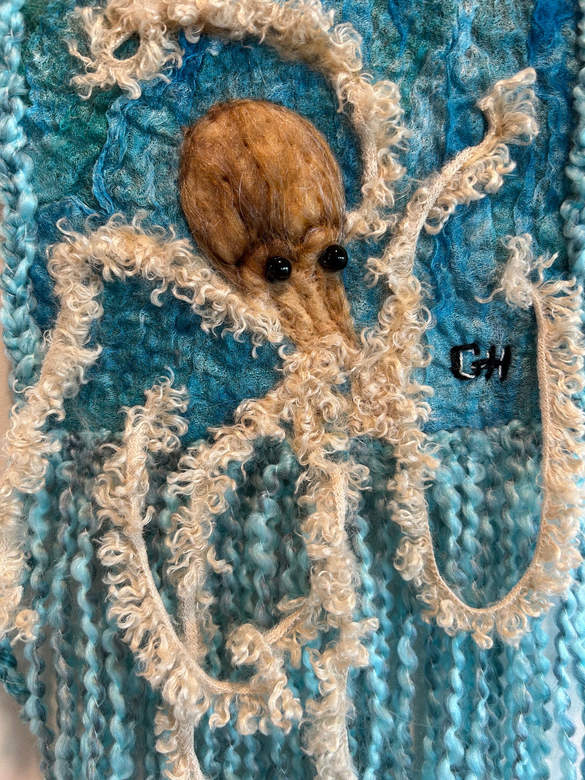 Tentacles - needle-felted octopus fibre art wall hanging by Gail Heinze, 13x7 inches plus fringe, hung from NS driftwood