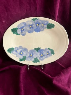 Baby blue pansies early blooms in the garden