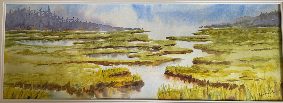Salt Marsh, Low Tide by Heather Crout, showing green marsh grasses, winding tidal channels and distant trees beneath a blue-grey sky.